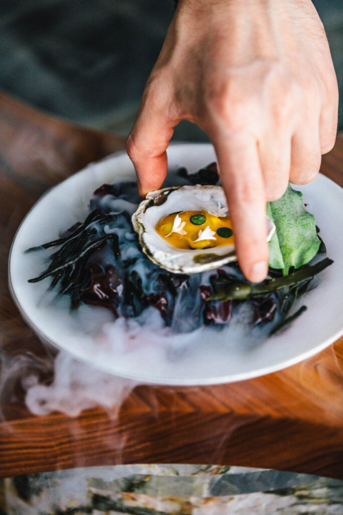 oyster and seaweed dish on the chef's table at até, a new culinary fine dining concept at The Dylan Amsterdam boutique hotel.